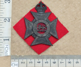 10719-3 Rhodesia Regiment helmet badge, large size, red flash backing (CO2990)